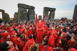 Druids, pagans and revellers gather at Stonehenge, hoping to see the sun rise, as they take part in a winter solstice ceremony at the ancient neolithic monument of Stonehenge