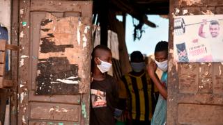 Boys in Ivory Coast wear masks