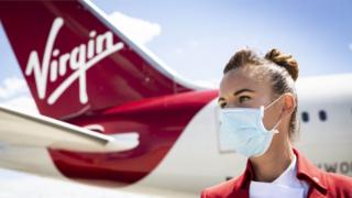 Cabin Crew Member, Natalie Burton prepares a Virgin Atlantic aircraft for the first passenger service after a three month pause due to Covid-19, London Heathrow Airport.