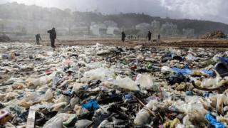 Trabalhadores limpam praia da cidade costeira de Zouk Mosbeh