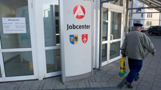 A man walks past an unemployment office