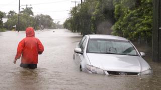 A man walks through floodwaters in Rosslea, Townsville, Queensland, Australia, 2 February 2019