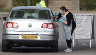 Medical staff testing people at a drive-through centre