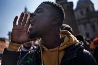A man takes part in a demonstration against the CFA franc in Rome, Italy, on 2 March 2019.