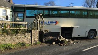 Coach crashes into wall