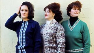 Three women pose wearing Fair Isle sweaters in Lerwick in 1970.