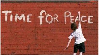 Boy and 'Time for Peace' written on a wall'