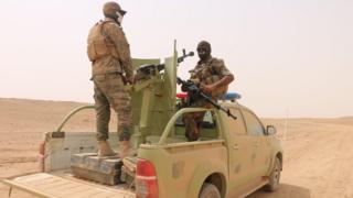 Paramilitary fighters stand on a vehicle south of Ana, in Anbar province, Iraq (20 September 2017)
