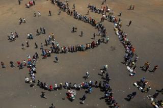 Mourners arrive at Rufaro stadium, in Mbare township