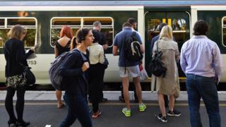 People waiting to get on to a train