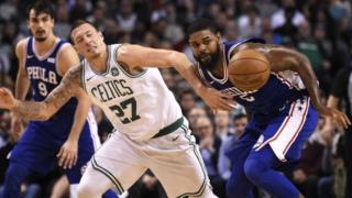 Boston Celtics forward Daniel Theis (27) and Philadelphia 76ers forward Amir Johnson (5) battle for a loose ball
