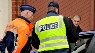 A Belgian (left) and a French police officers take part in a road traffic control in March 2013