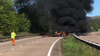 Plane in flames on the road