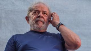 Бывший президент Луис Инасиу Лула да Силва жестом обращается к сторонникам