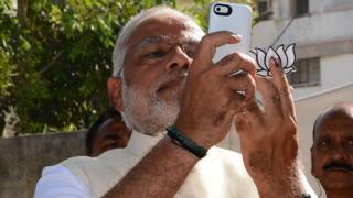 Indian Prime Minister Narendra Modi takes a 'selfie' after casting his vote at a polling station in Ahmedabad