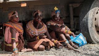 Women of the Turkana tribe rest in the shade of a truck during the 11th Marsabit Lake Turkana Culture Festival in Loiyangalani near Lake Turkana, northern Kenya, in a photo released on June 29, 2018. The annual 3-day festival featurs the cultural traditions of 14 ethnic tribes in Marsabit county to promote tourism and build better relationship between tribes