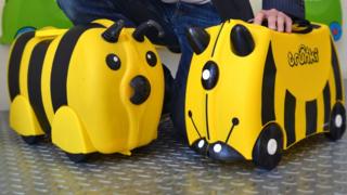 A Kiddee Case alongside a Trunki suitcase