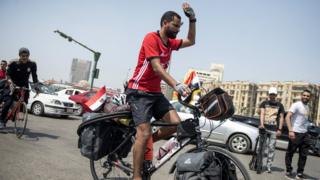 Mohamed "Ibn Nufal" Nufal on top im bicycle as e dey start im journey