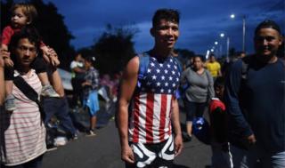 A young Honduran migrant wearing an American flag t-shirt