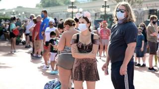 People queue outside Disney's Magic Kingdom