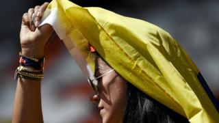 Colombia fan shelters from sun