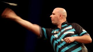 Rob Cross in action during the Premier League of Darts night in Cardiff