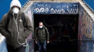 Passersby at the La Paz hospital in Madrid. Spain is in its fifth day of lockdown