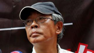 Bookseller Lam Wing-kee listens to a question from a journalist outside his Causeway Bay Books bookstore before taking part in a protest march in Hong Kong, China June 18, 2016.