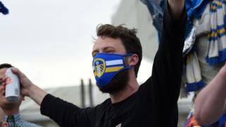 A fan wearing a Leeds United face mask