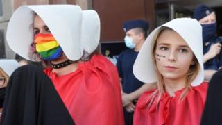 Two women wearing Handmaid's Tale costumes protest on Friday