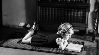 Girl reading on the floor