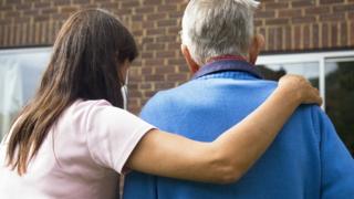 Elderly man being cared for