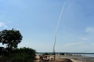 Bystanders watch as Indian Space Research Organisation"s (ISRO) CARTOSAT-2, along with 20 satellites from India, US, Canada, Germany and Indonesia on board the Polar Satellite Launch Vehicle (PSLV-C34), is launched from Sriharikota in the southern state of Andhra Pradesh on June 22, 2016. /