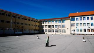 A woman walks towards a building in Bulgaria