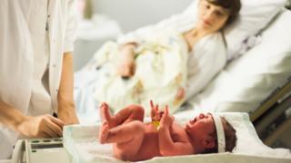 Newborn baby being checked