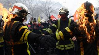 Firefighters set each other alight during a protest in the centre of Paris on 28 January
