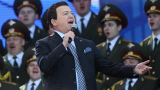 Singer Iosif Kobzon and a Russian military choir perform in a concert near Red Square on 18 March 2016