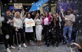 Owners and employees of the shop "Dona Manolita" celebrate selling the winning ticket of the biggest prize in Spain"s Christmas lottery "El Gordo"