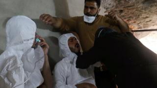 A man breathes through an oxygen mask as another one receives treatments, after what rescue workers described as a suspected gas attack in the town of Khan Sheikhoun in rebel-held Idlib, Syria April 4, 2017.