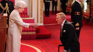 Sir Bruce Forsyth being knighted
