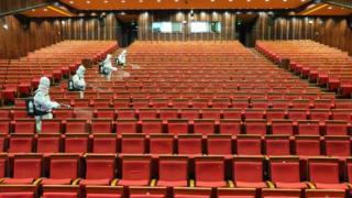 Disinfectant spraying at a cinema as it prepares to reopen in Yantai in China's eastern Shandong province.