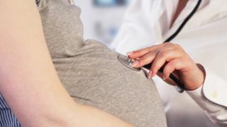 Pregnant woman with doctor