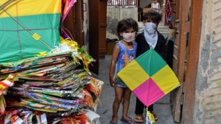 Children in Delhi holding a kite