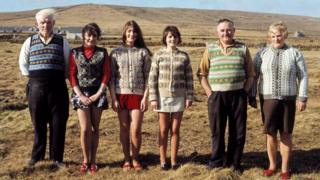 A family of Shetlanders pose wearing Fair Isle jumpers and tank tops on one of the Shetland Islands in June 1970