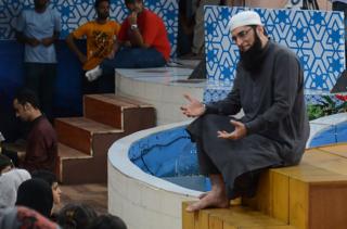 In this photograph taken on August 1, 2013, Pakistani television show host Junaid Jamshed (R) presents an Islamic quiz show Shan-e-Ramadan in Karachi.