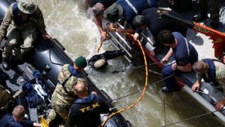 Rescuers search for bodies and survivors of the Danube tour boat accident in Budapest