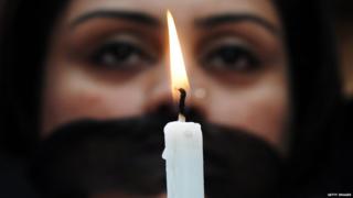 Indian members of a social organisation Our City Our Right holds a candle during a silent protest following the recent gang rape and murder of a 20-year-old college student in Barasat, in Kolkata on June 15, 2013.