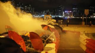 Riot police fire tear gas as they arrive to disperse protesters from the Legislative Council Building in Hong Kong, China, 02 July 2019.