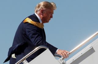 Money is seen in the back pocket of U.S. President Donald Trump as he boards Air Force One at Moffett Federal Airfield in California, USA. 17 September 2019.