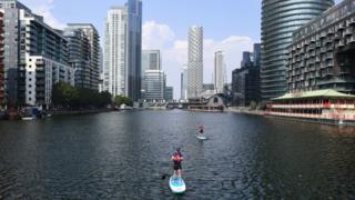 Paddleboarders off the Isle of Dogs, London, on Wednesday